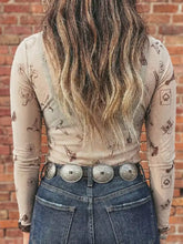 A silver-toned belt with four large engraved oval buckles paired with a slim fit mesh mock neck top
