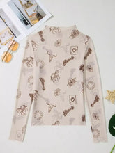 A beige slim fit mesh long sleeve top with a mock neck featuring cowboy-themed brown and gray illustrations