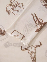Cream-colored sheer scarf with brown cowboy and bull skull pattern complementing a slim fit mesh long sleeve top