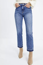High-waisted blue denim cropped jeans with whiskered wash and raw hem featuring frayed cuffs and straight-leg cut