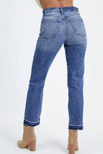 High-waisted blue denim cropped jeans with whiskered wash and raw hem featuring straight-leg cut and frayed cuffs