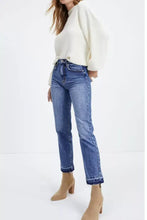 High-waisted blue denim cropped jeans with whiskered wash and raw hem featuring a straight-leg cut and rolled cuffs