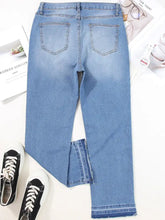 Light-wash denim cropped jeans with a whiskered wash and raw hem featuring a straight-leg cut and frayed edges