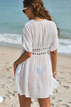 White short-sleeved beach cover-up with pom pom trim
