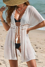 White crochet beach cover-up with pom pom trim and drawstring waist