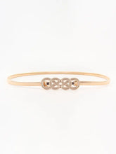 Gold infinity bangle with knot buckle metal belt accents