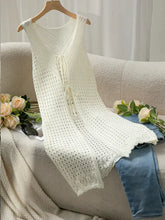 White sleeveless longline cardigan with crochet floral pattern and button closure