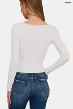 Woman in flattering neckline white crop top and blue jeans