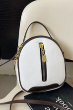 White PU leather handbag with brown trim and gold zipper