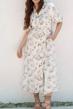 White floral print button-down dress with short sleeves and pockets