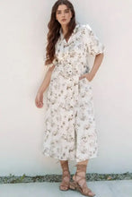 White floral print jumpsuit with ruffled short sleeves, button-down front, and pockets