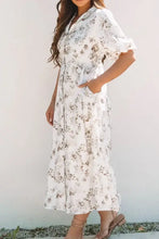 White floral print dress with puff sleeves and pockets
