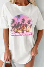 White graphic round neck half sleeve t-shirt dress with Beach Babe tropical sunset