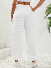 White high-waist quilted sweatpants with elasticated cuffs, full hip length