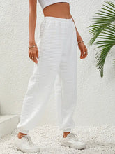 White high waist quilted sweatpants with elasticated cuffs on model