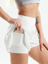 White high-waisted athletic shorts with tennis skirt, pockets, and crotch seam