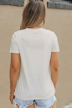 White lightning graphic round neck short sleeve t-shirt with frayed denim shorts and sunglasses