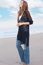 Long sleeve cardigan with side slits over wide-leg jeans