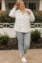 Plus size white long sleeve textured blouse with button front, distressed hem, pocket details