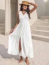 White sleeveless maxi dress with V-neck, lace trim, and thigh-high slit waist