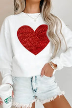 White sweatshirt featuring glitter red heart design