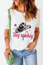White t shirt with cowboy hat graphic, black pink hat, stars, green strap