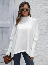 Woman in white turtleneck poncho sweater and sunglasses