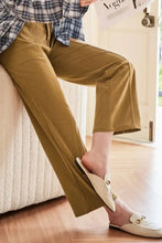 Mustard yellow corduroy relaxed fit wide-leg pants with white slip-on loafers
