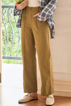 Olive green wide-leg relaxed fit pants with side slit and button detail
