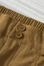 Brown corduroy wide-leg pants in mustard yellow, olive green, and brown with wooden buttons and elastic waistband
