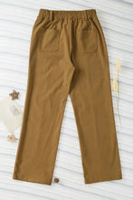Olive green wide-leg relaxed fit pants with elastic waist, pockets, button closure