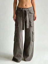 Gray wide leg cargo jeans featuring multiple pockets and a tied waistband for functional style and comfort