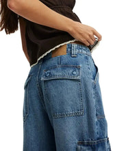 Blue denim wide leg cargo jeans with white lace trim at waistband and brown leather patch detail