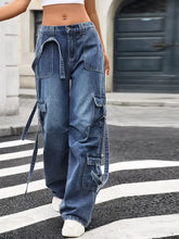 Wide leg blue denim cargo jeans featuring multiple pockets and adjustable side ties for a versatile fit