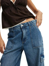 High-waisted blue denim wide leg cargo jeans with a relaxed fit and visible stitching details