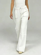 White wide-leg denim pants with contrast stitching and flared hem showcasing wide leg contrast design