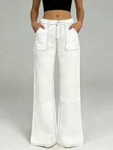 White wide leg denim jeans with high rise waist featuring black contrast stitching for a stylish leg contrast look