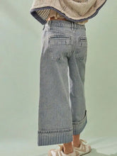 Light-wash denim wide-leg cropped jeans with rolled cuffs and a subtle striped hem for casual wear
