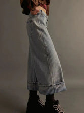 Wide-leg cropped jeans in light-wash denim with rolled cuffs and subtle striped texture for casual wear