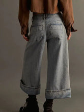 Wide-leg cropped jeans in faded light gray denim with rolled cuffs featuring ribbed detailing