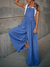Women’s light blue wide leg denim overalls with white tank top