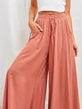 Coral high-waisted wide-leg pants with drawstring waist and pockets