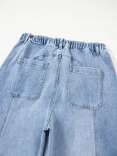 Back view of light-wash wide leg drawstring raw hem jeans with elastic waistband and two back pockets