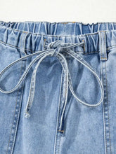 Light-wash denim wide leg drawstring raw hem shorts with elastic waistband and matching drawstring closure