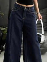 Dark blue high-waisted wide leg jeans with white stitching and gold-tone button in denim material