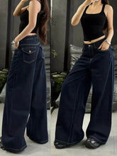 Dark indigo wide leg jeans in denim with contrasting white stitching and classic five-pocket design