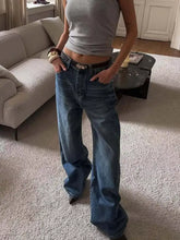 Wide leg relaxed fit blue denim jeans with classic five-pocket design and dark brown belt