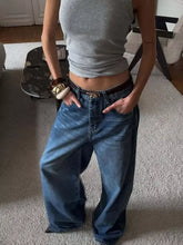Wide leg relaxed fit blue denim jeans with a dark brown belt and gold toned buckle for casual wear