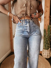 Wide leg wash jeans high-waisted light blue denim with classic straight-leg cut and visible stitching details