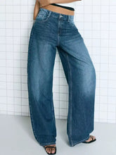 Wide leg washed denim jeans in medium blue with high waist classic stitching and belt loops for versatile wear